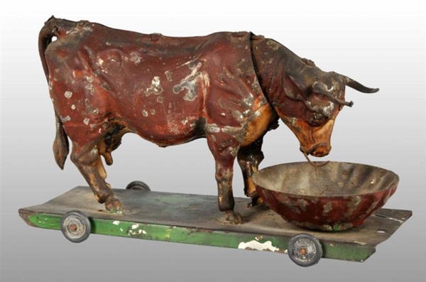 TIN HAND-PAINTED BULL PLATFORM WIND-UP TOY.       