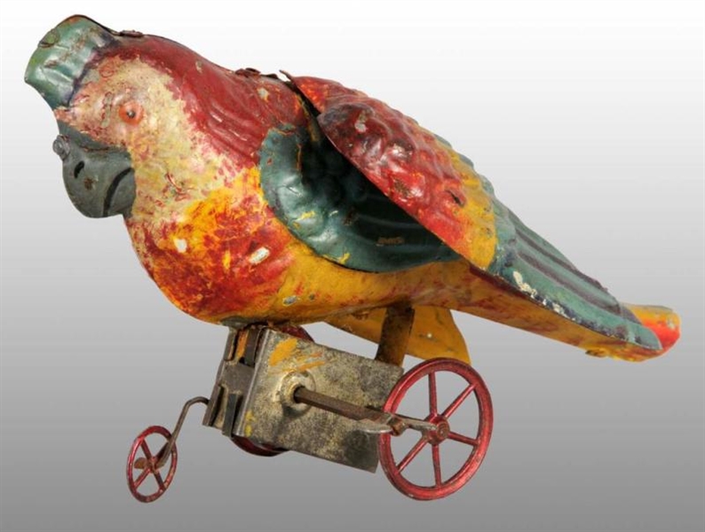 TIN HAND-PAINTED PARROT WIND-UP TOY.              