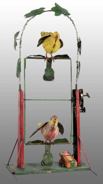 TIN HAND-PAINTED DOUBLE BIRD SWING WIND-UP TOY.   