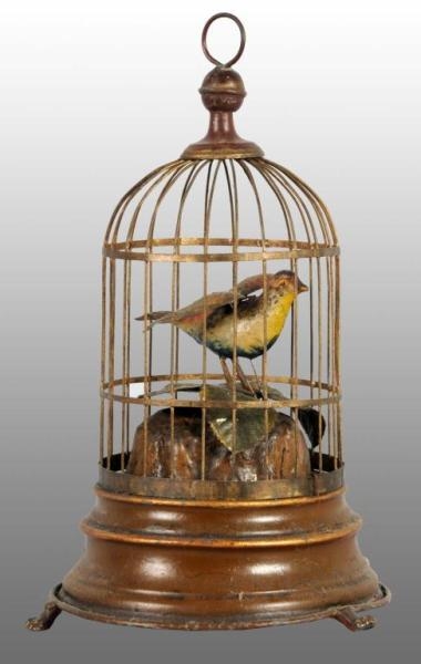 TIN HAND-PAINTED BIRDCAGE WIND-UP TOY.            
