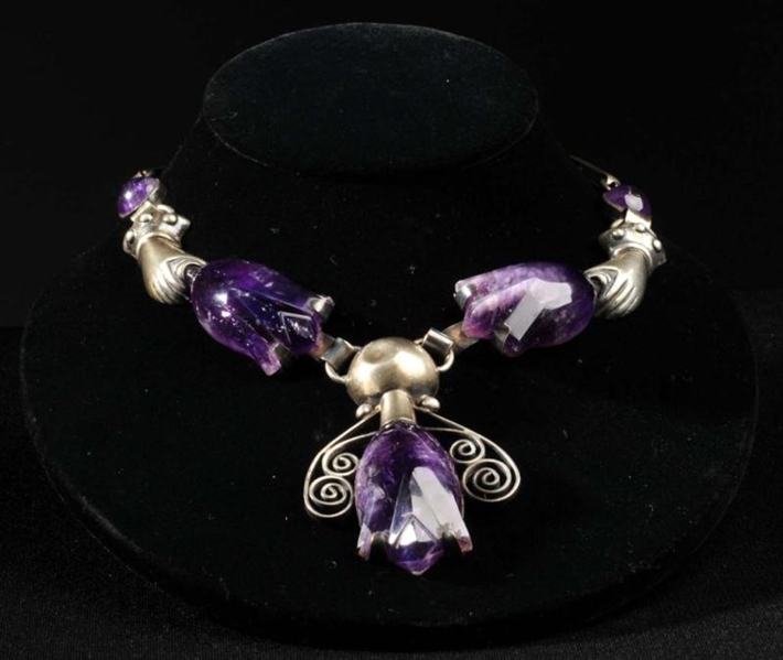 HANDS WITH AMETHYST TULIPS NECKLACE.              