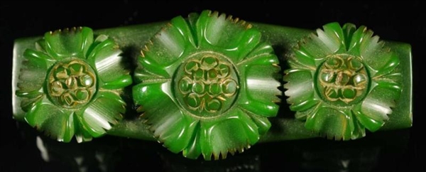 BAKELITE GREEN PIN WITH MOVEABLE FLOWERS.         