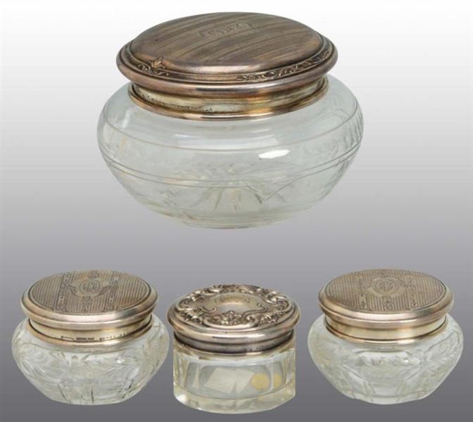 LOT OF 4: CUT GLASS JARS WITH STERLING LIDS.      