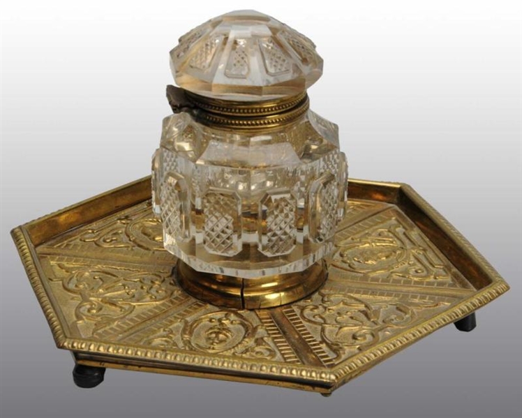 CUT GLASS INKWELL ON BRASS BASE.                  