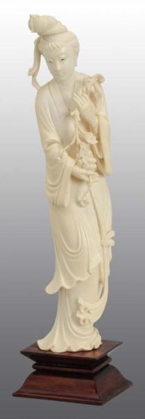 IVORY FIGURE OF CHINESE LADY HOLDING GRAPES.      