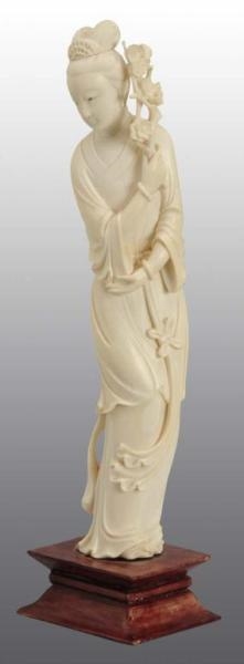 IVORY FIGURE OF CHINESE WOMAN HOLDING A FLOWER.   