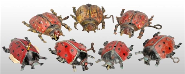 LOT OF 7: TIN LITHO BEETLE PULL & WIND-UP TOYS.   