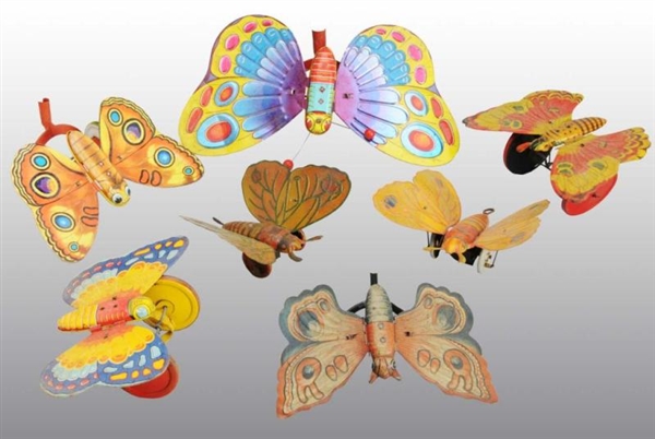 LOT OF 7: TIN LITHO BUTTERFLY TOYS.               