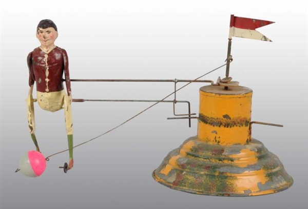 TIN HAND-PAINTED BOY KICKING BALL WIND-UP TOY.    