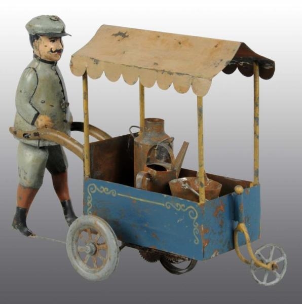 TIN HAND-PAINTED MAN PUSHING CART WIND-UP TOY.    