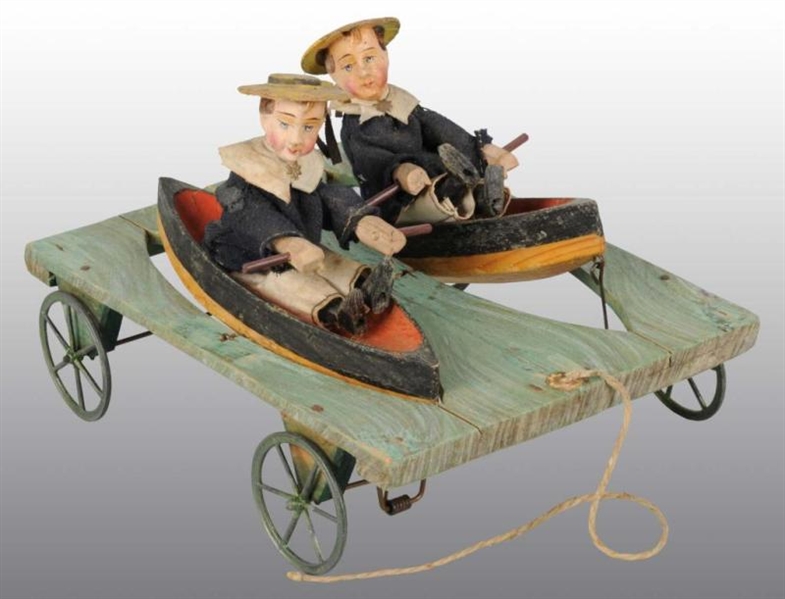 PULL TOY WITH TWO BOYS IN BOATS.                  