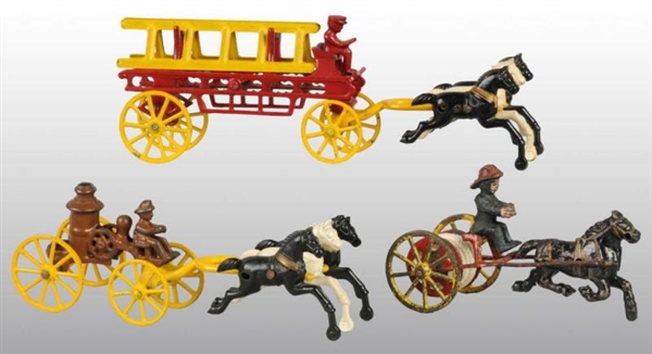 LOT OF 3: CAST IRON HORSE-DRAWN FIRE TOYS.        