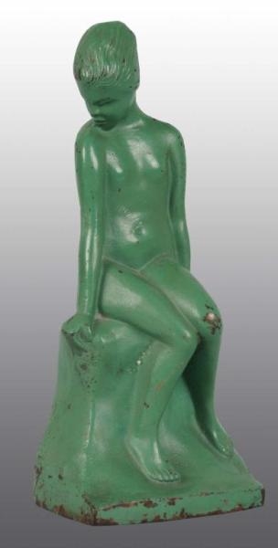 CAST IRON SITTING NUDE WOMAN BOOKEND.             