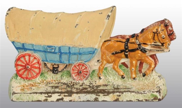 COVERED WAGON WITH TEAM OF HORSES DOORSTOP.       