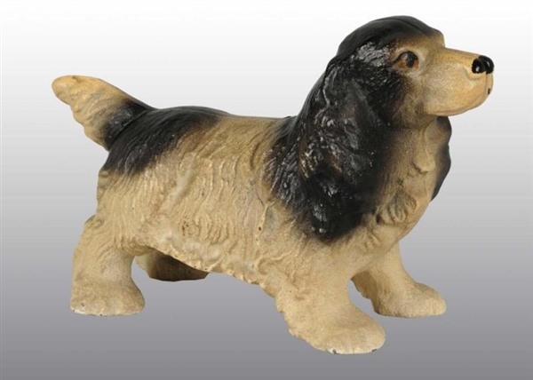 CAST IRON SPANIEL WITH TRAP STILL BANK.           