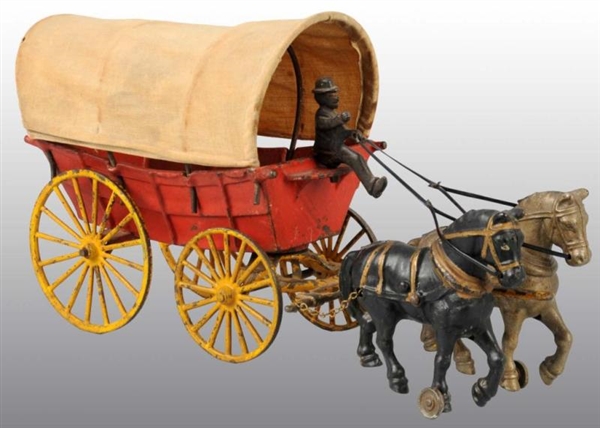 CAST IRON HUBLEY HORSE-DRAWN COVERED WAGON TOY.   