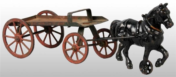 CAST IRON HORSE-DRAWN FLAT BED WAGON TOY.         