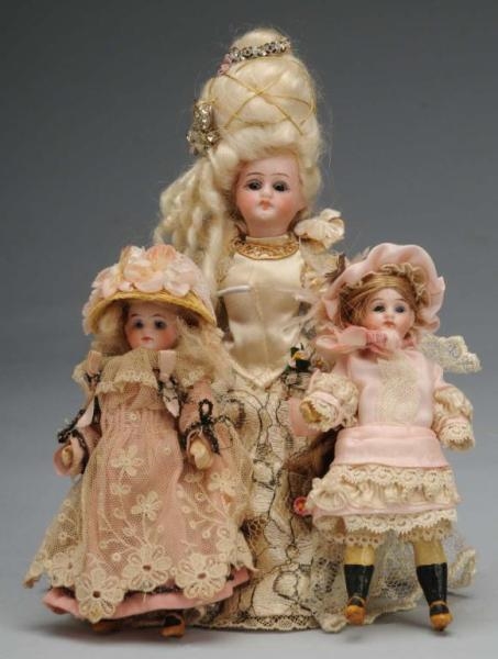 LOT OF 3: BISQUE DOLLS.                           