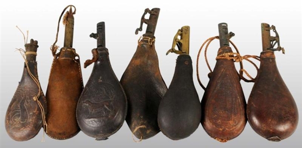 LOT OF 7: LEATHER POWDER FLASKS.                  