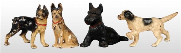 LOT OF 4: ASSORTED CAST IRON DOG PAPERWEIGHTS.    