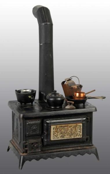 CAST IRON DAINTY CHILDS TOY STOVE.               