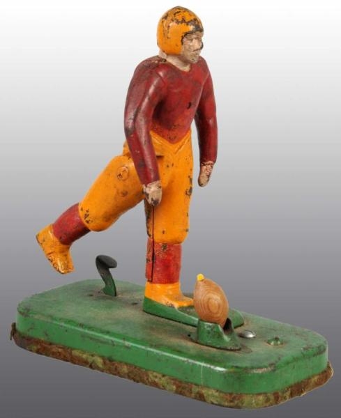 CAST IRON MECHANICAL FOOTBALL PLAYER TOY.         