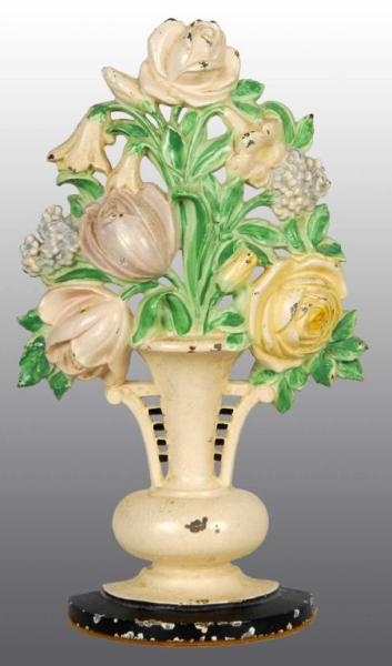 CAST IRON TULIPS AND ROSES IN URN DOORSTOP.       