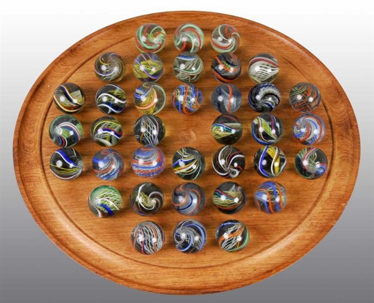SOLITAIRE BOARD WITH 36 SWIRL MARBLES.            