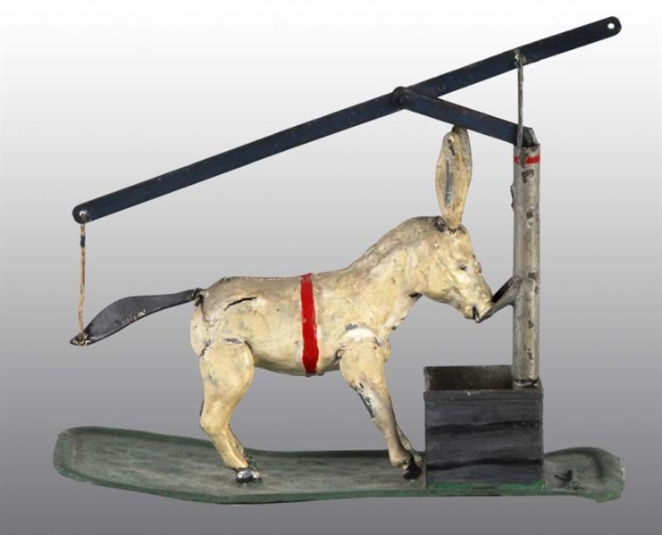 TIN HAND-PAINTED DONKEY & THE WELL PLATFORM TOY.  