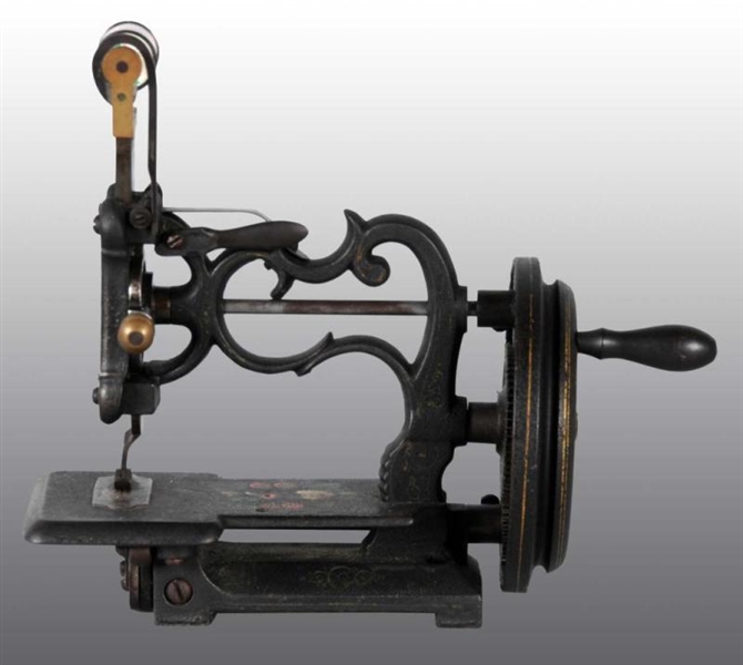 CAST IRON CHILDS TOY SEWING MACHINE.             