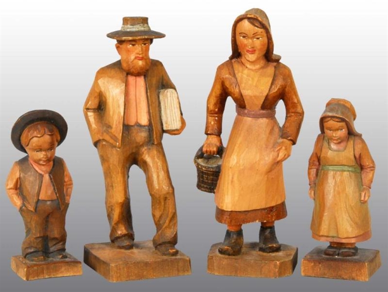LOT OF 4: CARVED WOODEN FIGURES OF AMISH.         