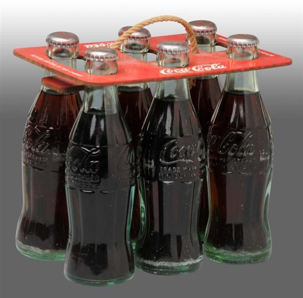 COCA-COLA 6-PACK CARRIER WITH BOTTLES.            