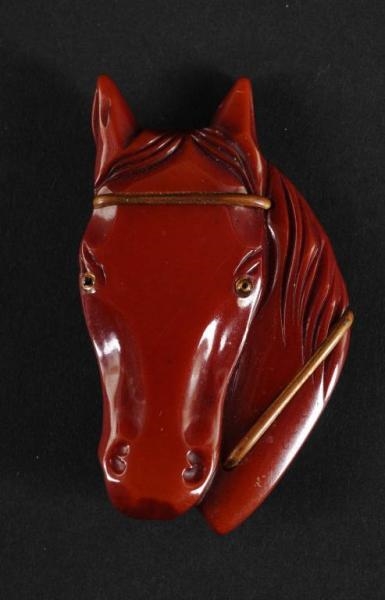 BAKELITE DARK RED HORSE HEAD PIN.                 