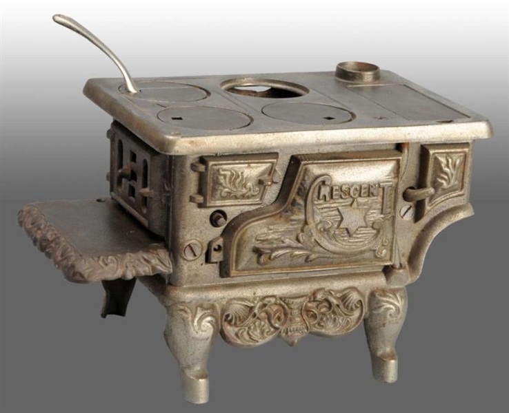 CAST IRON RESCENT TOY CHILDRENS STOVE.           