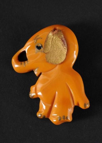BAKELITE GOLD ELEPHANT PIN WITH LEATHER EAR.      