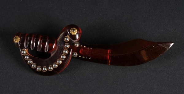 BAKELITE AMBER COLORED SWORD WITH STUDDED HANDLE. 