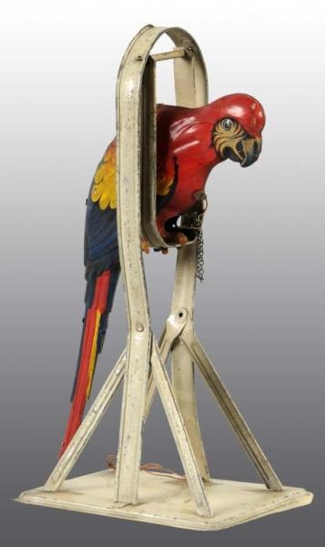 TIN PARROT ON SWING WIND-UP TOY.                  