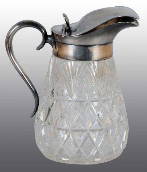 CUT GLASS SYRUP DISPENSER WITH SILVER TOP.        