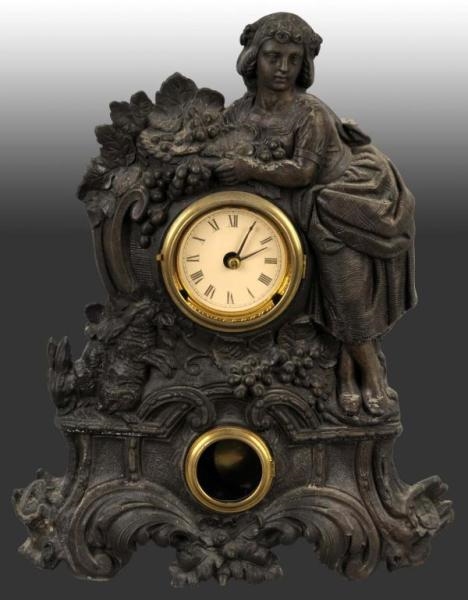 METAL TIME & STRIKE CLOCK WITH WOMAN & RABBITS.   