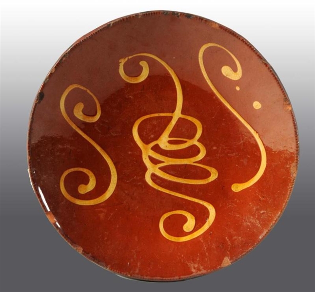 EARLY REDWARE SLIP DECORATED PLATE.               