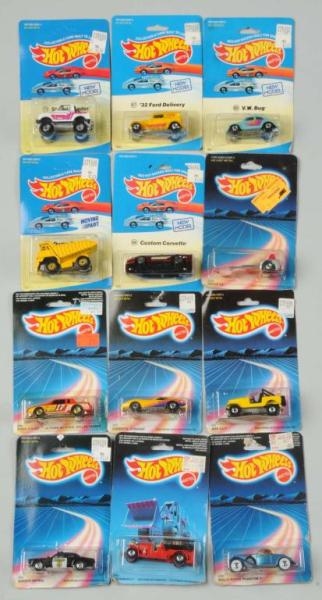 LOT OF 12: HOT WHEELS FOREIGN-PACKAGED VEHICLES.  