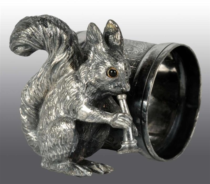 GLASS EYED SQUIRREL PLAYING HORN NAPKIN RING.     