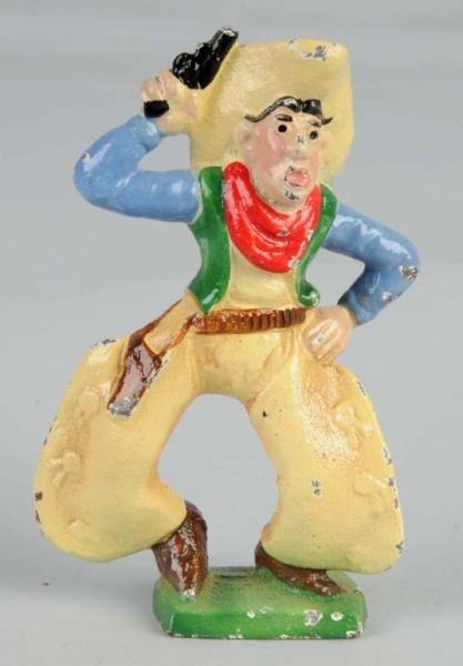 CAST IRON COWBOY WITH SIX SHOOTER PAPERWEIGHT.    