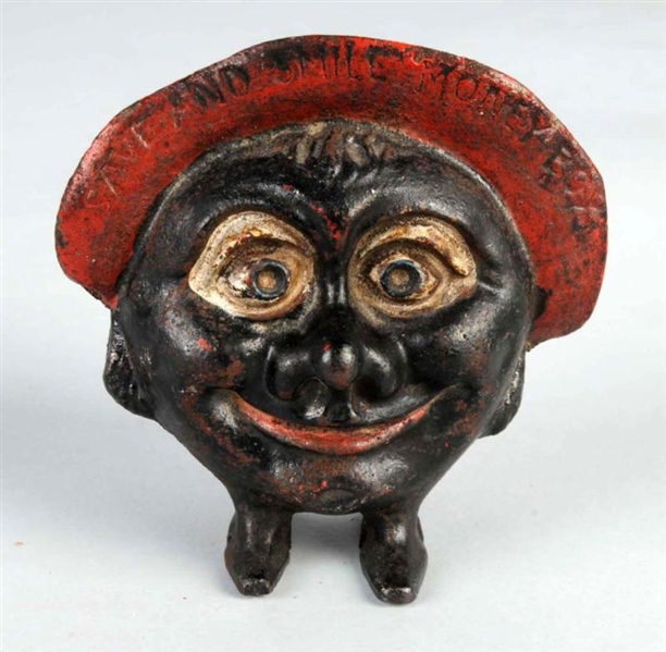 CAST IRON SAVE AND SMILE MONEY BANK.              