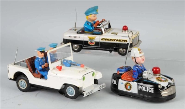 LOT OF 3: TIN POLICE CAR BATTERY-OP TOYS.         