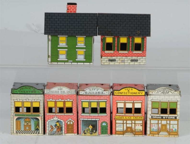 LOT OF 7: TIN CANDY CONTAINER BUILDINGS.          