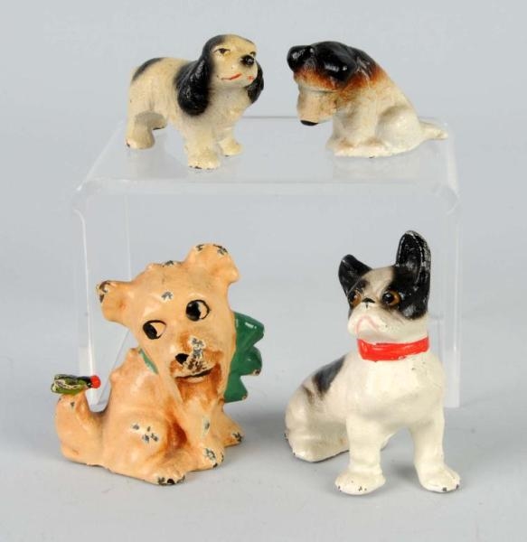LOT OF 4: CAST IRON DOG PAPERWEIGHTS.             