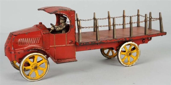 CAST IRON DENT FLATBED STAKE TRUCK TOY.           