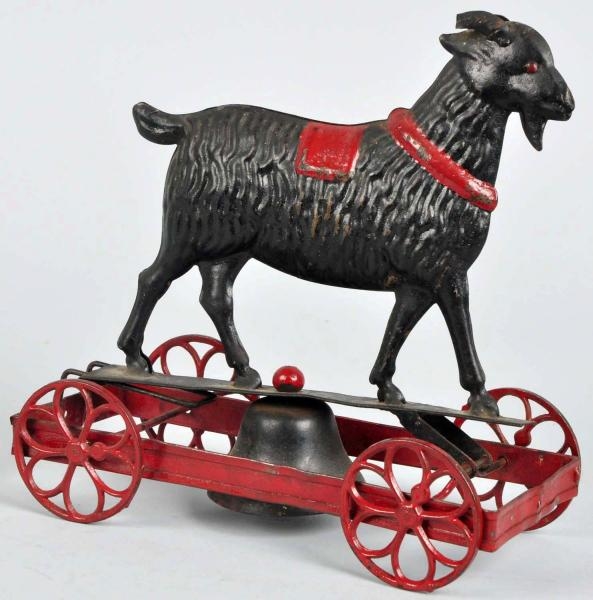EARLY HANDPAINTED TIN GOAT ON PLATFORM BELL TOY.  