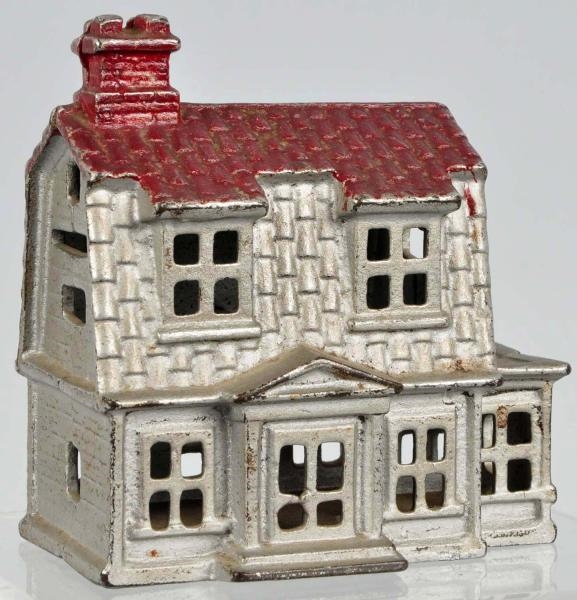 CAST IRON COLONIAL HOUSE WITH PORCH STILL BANK.   